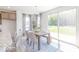Dining area with a wood table, upholstered chairs, and sliding glass doors that open to the backyard at 4739 E Shadowbrook Dr, Camby, IN 46113