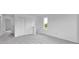 Hallway featuring neutral carpet, white walls, double closets, and a window with green outdoor view at 4739 E Shadowbrook Dr, Camby, IN 46113