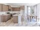 Open kitchen with island, stainless steel appliances, dining area, and lots of natural light at 4739 E Shadowbrook Dr, Camby, IN 46113