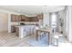 Bright kitchen featuring an island with bar seating, a dining table, and neutral-toned cabinets at 4739 E Shadowbrook Dr, Camby, IN 46113