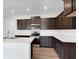 Bright kitchen featuring dark wood cabinets, modern stainless steel appliances, light countertops and wood floor at 4739 E Shadowbrook Dr, Camby, IN 46113
