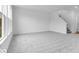 Large living room with neutral carpet, white walls and trim, a window and staircase leading to the upper level at 4739 E Shadowbrook Dr, Camby, IN 46113