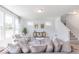 Spacious living room with large windows providing natural light and hardwood-style floors at 4739 E Shadowbrook Dr, Camby, IN 46113