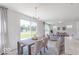 Open-concept living room and dining area with a view of the backyard and a comfortable seating area at 4739 E Shadowbrook Dr, Camby, IN 46113