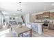 An open-concept living space that features a modern kitchen and cozy living area with plenty of natural light at 4739 E Shadowbrook Dr, Camby, IN 46113