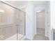 Bathroom shower featuring glass doors, a tile surround, and a shower head at 4739 E Shadowbrook Dr, Camby, IN 46113