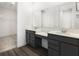 Double vanity bathroom featuring a dressing table between the sinks, a large mirror, and modern fixtures at 5771 Cr W 750 N, McCordsville, IN 46055