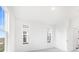 Sunlit bedroom with carpet, white walls, two double hung windows and an open doorway to the bathroom at 5771 Cr W 750 N, McCordsville, IN 46055