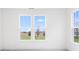 Bright bedroom with multiple windows showcasing scenic views of surrounding greenery and blue skies at 5771 Cr W 750 N, McCordsville, IN 46055
