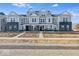 New construction townhome featuring gray siding, black brick, and covered porches in a modern style at 5771 Cr W 750 N, McCordsville, IN 46055