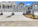 A row of modern townhomes featuring individual garages and neutral siding at 5771 Cr W 750 N, McCordsville, IN 46055