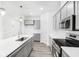 Modern kitchen with stainless steel appliances, gray cabinetry, and an island with a sink at 5771 Cr W 750 N, McCordsville, IN 46055
