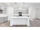 Modern kitchen with gray cabinets, a white island, stainless steel appliances, and stylish pendant lighting at 5771 Cr W 750 N, McCordsville, IN 46055