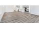 Open-concept living space with modern flooring, white walls, and a view of the kitchen at 5771 Cr W 750 N, McCordsville, IN 46055