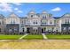 Charming townhome showcases brick accents, gray siding, and a well-manicured lawn under a bright, sunny sky at 5777 Cr W 750 N, McCordsville, IN 46055