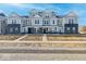 Attractive townhome with gray siding, black brick accents, and inviting front porches at 5777 Cr W 750 N, McCordsville, IN 46055
