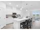 Open concept kitchen with a quartz island, modern stools, and stainless steel appliances at 5777 Cr W 750 N, McCordsville, IN 46055