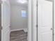 Bright laundry room with a window and luxury vinyl plank flooring viewed through an open doorway at 5777 Cr W 750 N, McCordsville, IN 46055