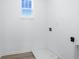 Clean laundry room with wood-look flooring and a window providing natural light at 5777 Cr W 750 N, McCordsville, IN 46055