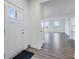 Bright foyer with a white front door, adjacent coat closet, and views of the spacious living area at 5785 Cr W 750 N, McCordsville, IN 46055