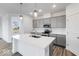 Modern kitchen featuring a white island, stainless steel appliances, gray cabinets, and stylish lighting at 5785 Cr W 750 N, McCordsville, IN 46055