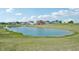 Scenic view of a pond in the community, surrounded by green space and residential homes at 5785 Cr W 750 N, McCordsville, IN 46055