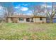 The stone house has a spacious backyard that's perfect for entertaining, surrounded by mature trees at 5984 Williams Dr, Plainfield, IN 46168