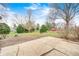 Large concrete patio leading to a spacious backyard with mature trees at 5984 Williams Dr, Plainfield, IN 46168
