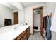 Well-lit bathroom with dual sinks, framed mirror, and wood cabinets at 5984 Williams Dr, Plainfield, IN 46168
