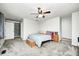 Comfortable bedroom featuring plush carpet, a ceiling fan, and a window for natural light at 5984 Williams Dr, Plainfield, IN 46168