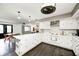 Bright eat-in kitchen features white cabinets, modern appliances, and hardwood floors overlooking the Gathering room at 5984 Williams Dr, Plainfield, IN 46168