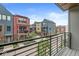 Balcony view showcasing colorful condos with brick and siding exteriors, complemented by manicured landscaping at 622 E 10Th St # 206, Indianapolis, IN 46202