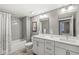 Well-lit bathroom with double vanity, modern fixtures, and subway tile in the shower and tub at 622 E 10Th St # 206, Indianapolis, IN 46202