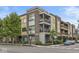 Exterior view of a modern condo with multiple balconies, brick accents, and landscaped surroundings at 622 E 10Th St # 206, Indianapolis, IN 46202