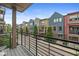 View from a balcony showcasing colorful condos with brick and siding exteriors, complemented by manicured landscaping at 622 E 10Th St # 206, Indianapolis, IN 46202