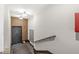 This is an image of a staircase inside of a building, there is a doorway to the left, and mailboxes by the stairwell at 622 E 10Th St # 206, Indianapolis, IN 46202