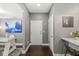 Hallway featuring hardwood floors, gray walls, white doors, and artwork, creating a clean and modern aesthetic at 622 E 10Th St # 206, Indianapolis, IN 46202
