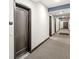 Apartment hallway with neutral carpets and walls showcasing entry door and apartment number at 622 E 10Th St # 206, Indianapolis, IN 46202