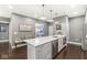 Kitchen featuring a large island with seating, stainless steel appliances, and modern finishes at 622 E 10Th St # 206, Indianapolis, IN 46202