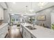Open concept kitchen features stainless steel appliances, white cabinets, and a view to the living area at 622 E 10Th St # 206, Indianapolis, IN 46202
