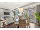 Bright living room showcasing hardwood floors, modern lighting, and outdoor view from a cozy chair setting at 622 E 10Th St # 206, Indianapolis, IN 46202