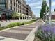 Street view of Indianapolis featuring a tree-lined, walkable path and adjacent buildings at 622 E 10Th St # 206, Indianapolis, IN 46202