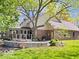 A spacious backyard featuring a deck and a stone-walled patio at 6744 Robin Hood Ct, Indianapolis, IN 46227