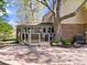 A large brick patio and deck are nestled near the house around a mature tree at 6744 Robin Hood Ct, Indianapolis, IN 46227