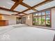 Finished basement with tiered floor, wet bar, large windows and carpet flooring at 6744 Robin Hood Ct, Indianapolis, IN 46227