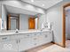Bright bathroom with dual sinks, large mirror, neutral finishes and good lighting at 6744 Robin Hood Ct, Indianapolis, IN 46227