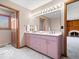 Bathroom with double vanity, good lighting, neutral colors and door to bedroom at 6744 Robin Hood Ct, Indianapolis, IN 46227