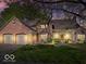 Charming brick home with a well-maintained lawn, mature trees, and a three-car garage at 6744 Robin Hood Ct, Indianapolis, IN 46227