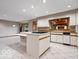Spacious kitchen with center island, white cabinets and tile flooring; open to an additional room at 6744 Robin Hood Ct, Indianapolis, IN 46227