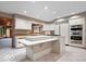 Well-appointed kitchen featuring white cabinetry, stainless steel appliances, and a large center island at 6744 Robin Hood Ct, Indianapolis, IN 46227
